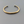 Load image into Gallery viewer, Gold bracelet on a dark gray background