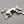 Load image into Gallery viewer, Silver frog brooch on a dark gray background