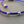 Load image into Gallery viewer, Blue macrame bracelet with silver beads on a gray background