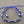 Load image into Gallery viewer, Blue bracelet with silver beads on a gray background