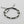 Load image into Gallery viewer, Black macrame bracelet with silver beads on a gray background