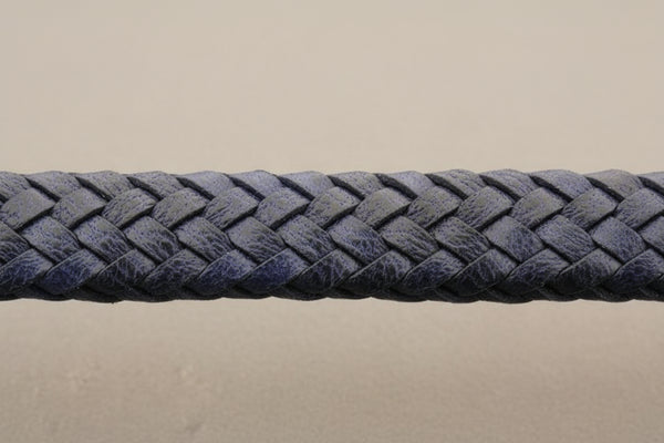 Close-up of a blue braided leather bracelet on a gray background