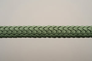 Close-up of a green braided rope on a gray background