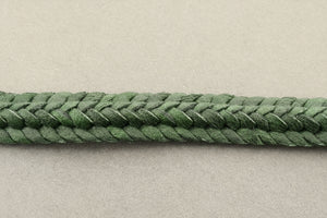 Close-up of a green braided rope on a gray background