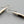 Load image into Gallery viewer, Seed shaped copper & silver earrings with bronzed calcite & obsidian