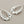 Load image into Gallery viewer, Silver earrings on a dark gray background