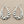 Load image into Gallery viewer, Pair of silver hoop earrings on a dark background