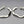 Load image into Gallery viewer, Pair of silver hoop earrings on a gray background