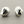 Load image into Gallery viewer, Pair of silver shell-shaped earrings on a gray background