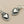Load image into Gallery viewer, Silver heart-shaped earrings on a gray background