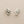 Load image into Gallery viewer, Silver peace symbol earrings on a gray background