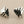 Load image into Gallery viewer, Pair of silver fish-shaped earrings on a gray background