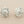 Load image into Gallery viewer, Pair of silver sunflower-shaped earrings on a gray background
