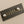 Load image into Gallery viewer, Black rectangular label with 'MAKERS PROVIDERS' text and two silver knobs on a gray background