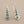 Load image into Gallery viewer, Pair of silver earrings with turquoise stones on a gray background