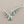 Load image into Gallery viewer, Silver earrings with turquoise stones on a gray background