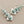 Load image into Gallery viewer, Silver earrings with turquoise stones on a gray background