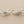 Load image into Gallery viewer, Pair of silver branch-like earrings on a gray background