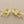 Load image into Gallery viewer, Gold branch-shaped earrings on a gray background