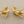 Load image into Gallery viewer, Gold branch-like earrings on a gray background