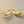 Load image into Gallery viewer, Pair of gold branch-shaped earrings on a gray background