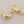Load image into Gallery viewer, Pair of gold branch-shaped earrings on a gray background