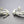 Load image into Gallery viewer, Pair of silver leaf-like earrings on a gray background
