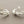 Load image into Gallery viewer, Pair of silver leaf-like earrings on a gray background