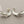 Load image into Gallery viewer, Pair of silver branch-like earrings on a dark gray background