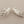 Load image into Gallery viewer, Pair of silver leaf-shaped earrings on a gray background