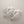 Load image into Gallery viewer, Pair of silver leaf-like earrings on a dark gray background