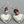 Load image into Gallery viewer, Pair of silver heart-shaped earrings with orange beads on a gray background