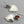Load image into Gallery viewer, Pair of silver heart-shaped earrings with orange stones on a gray background