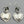 Load image into Gallery viewer, Pair of silver heart-shaped earrings on a gray background