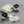 Load image into Gallery viewer, Pair of silver leaf-shaped earrings with black accents on a gray background