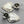 Load image into Gallery viewer, Silver heart-shaped earrings with floral details on a gray background