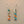 Load image into Gallery viewer, Pair of earrings with rectangular multicolored stones on a gray background