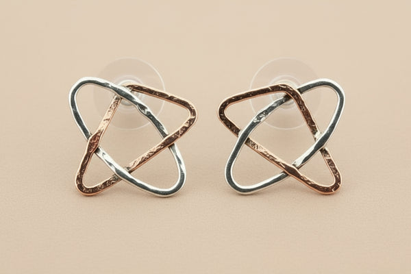 Pair of geometric earrings on a gray background
