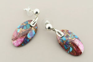 Multicolored stone earrings on a gray background