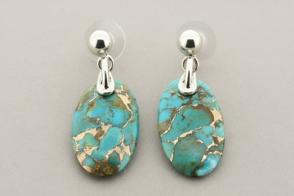 Turquoise stone earrings with silver posts on a gray background