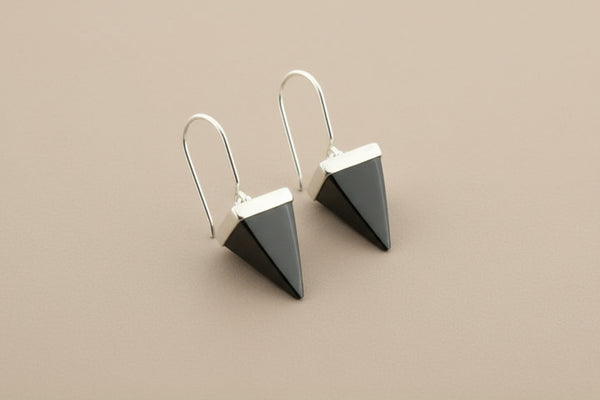 Pair of geometric earrings on a gray background