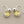 Load image into Gallery viewer, Pair of silver earrings with yellow gemstones on a dark gray background