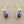 Load image into Gallery viewer, Pair of silver earrings with blue gemstones on a gray background