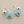 Load image into Gallery viewer, Silver earrings with turquoise stones on a gray background