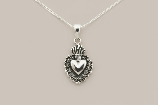 Silver pendant necklace on a gray background