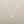 Load image into Gallery viewer, Gold teardrop pendant on a silver chain against a gray background