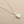 Load image into Gallery viewer, Silver necklace with a small round pendant on a gray background