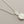 Load image into Gallery viewer, Silver necklace with a detailed pendant on a gray background