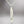 Load image into Gallery viewer, Silver fish-shaped pendant on a chain against a gray background