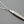 Load image into Gallery viewer, Silver tassel pendant on a chain against a dark background